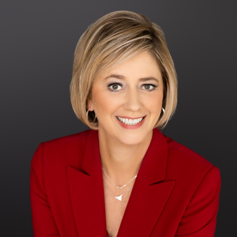 Lori_Wall seen with a bright smile on her face and in a red color outfit
